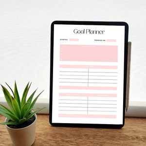 May include: A digital tablet displaying a Goal Planner template with pink headers and sections for steps to take, action steps, what worked, what didn't, and overall performance. The screen includes fields for started and finished dates.