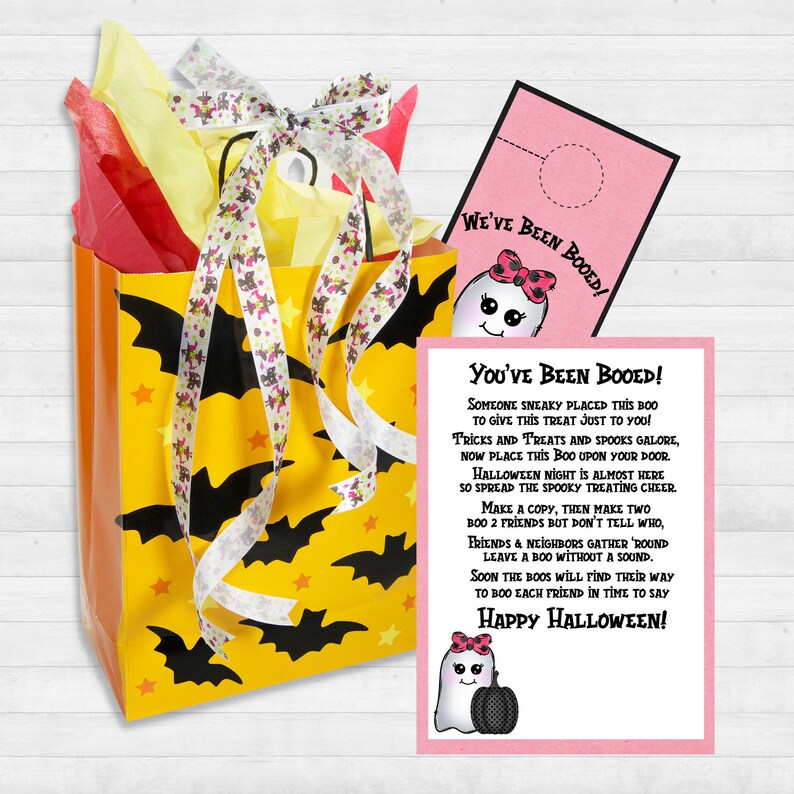 May include: A pink and white card with a ghost illustration and the text "You've Been Booed!"  Someone sneaky placed this boo to give this treat just to you! Tricks and treats and spooks galore, now place this boo upon your door. Halloween night is almost here so spread the spooky treating cheer. Make a copy, then make two, boo 2 friends but don't tell who. Friends and neighbors gather 'round leave a boo without a sound. Soon the boos will find their way to boo each friend in time to say Happy Halloween!"