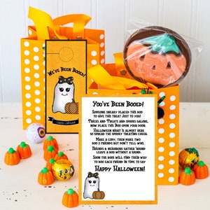 May include: A printable Halloween "You've Been Booed!" sign with a cute ghost illustration and instructions for a fun neighborhood tradition. The sign is printed on white paper with black text and a yellow background.