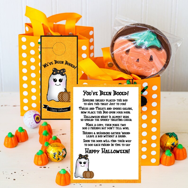 May include: A printable Halloween "You've Been Booed!" sign with a cute ghost illustration and instructions for a fun neighborhood tradition. The sign is printed on white paper with black text and a yellow background.