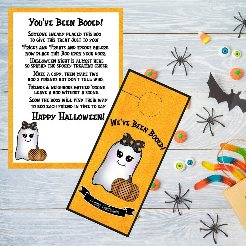 May include: A printable Halloween door hanger featuring a cute ghost with a pumpkin and the text "You've Been Booed!" and "We've Been Booed!"