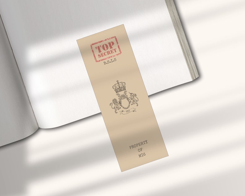 May include: A tan bookmark with a red "TOP SECRET" stamp and the text "B.S.I.S."  The bookmark also features a black and white illustration of a crown and two lions with the text "PROPERTY OF MIG".