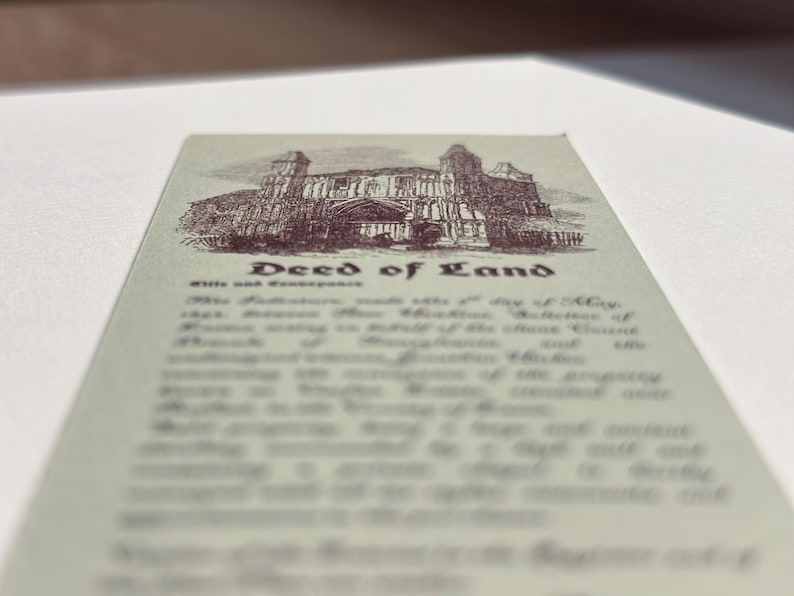 May include: A vintage deed of land document with an illustration of a building at the top. The text "Deed of Land" is centered, with smaller text below. The document has a sepia tone.