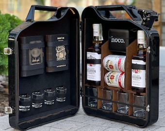 May include: A black, open, jerry can-shaped bar cabinet. Inside are two bottles of Jim Beam Bourbon, two cans of Jim Beam & Cola, shot glasses, and a wallet. The left side has a space for cigars and cards.