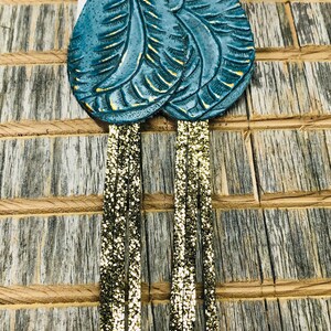 Large teardrop teal tooled with gold metallic fringe earrings