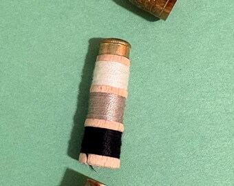 Brass  (or copper-toned) acorn/bullet-shaped sewing etui (chatelaine sewing kit), likely late 19th–early 20th century