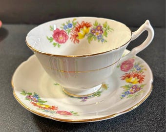 Collingwoods Bone China England teacup and saucer set with a multi-color floral bouquet pattern.