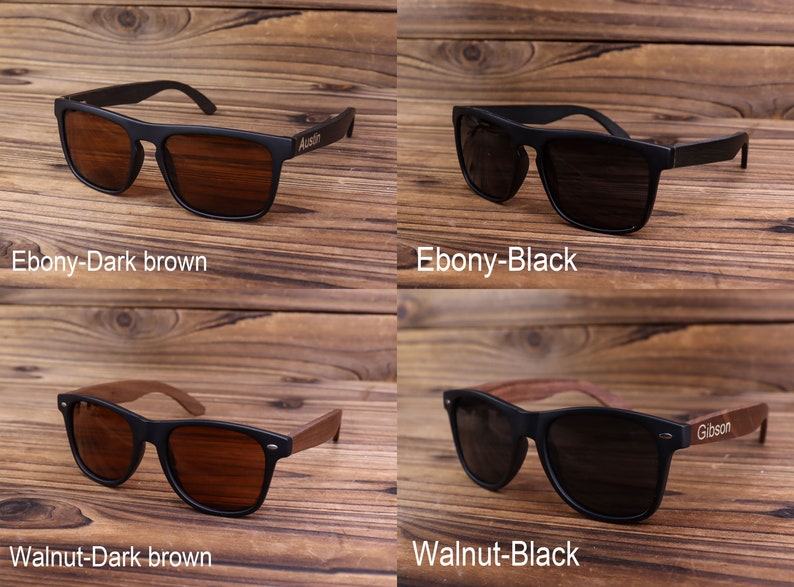 May include: Four pairs of sunglasses with wooden arms. The sunglasses have black frames and either dark brown or black lenses. The wooden arms are either ebony or walnut.