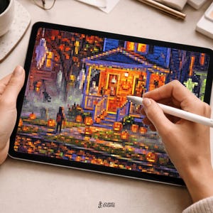 May include: A digital tablet displaying a pixel art illustration of a house decorated for Halloween with orange pumpkins, glowing windows, and autumn foliage. A white stylus is held against the screen, which features a dark, festive scene.