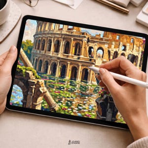May include: A digital tablet displaying a pixelated illustration of the Roman Colosseum. The screen shows the ancient stone amphitheater with arched levels and a foreground of green foliage and colorful flowers. A white stylus is held against the screen.