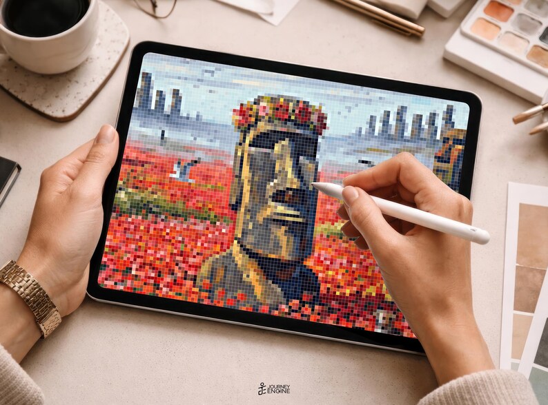 May include: A tablet displaying a pixel art illustration of a Moai statue wearing a floral crown, set against a field of red flowers and a distant cityscape. The digital artwork features a color palette of gray, red, and blue tones in a grid format.