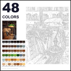 May include: A paint-by-numbers kit featuring 48 colors and a line art template of a cat sleeping on a desk next to a lamp and books. The kit includes a small reference image showing the finished scene with a green lamp and a tabby cat.