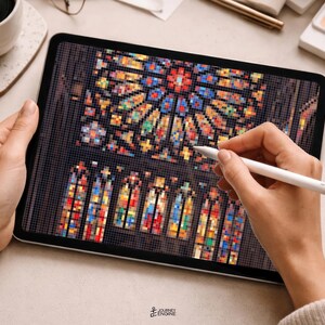 May include: A tablet displaying a digital pixel art illustration of a stained glass rose window and arched windows. The screen shows a vibrant mosaic of red, blue, yellow, and green squares arranged to form intricate architectural patterns.