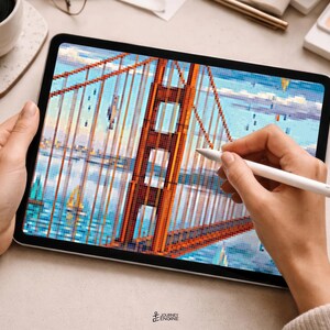 May include: A tablet displaying a pixelated digital illustration of the Golden Gate Bridge in orange, set against a blue sky and water background. A white stylus is held against the screen, which also features the text Journey Engine at the bottom.