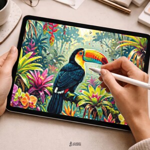 May include: A digital tablet displaying a pixelated illustration of a toucan perched amidst vibrant tropical foliage, including pink bromeliads and yellow flowers. The screen shows a detailed mosaic-style artwork with a colorful bird and plants.