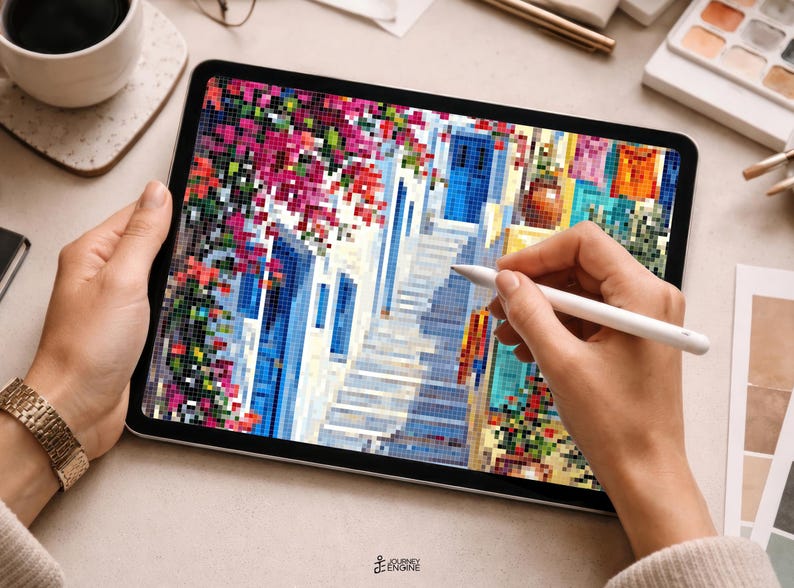 May include: A digital tablet displaying a pixelated art illustration of a Mediterranean street scene with vibrant pink bougainvillea, a blue door, and stone steps. The screen shows a colorful mosaic-style image being edited with a white stylus.