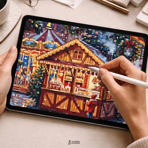 May include: A digital tablet displaying a pixel art illustration of a festive wooden market stall with warm yellow lighting, a peaked roof, and holiday decorations, being edited with a white stylus on a light-colored surface.