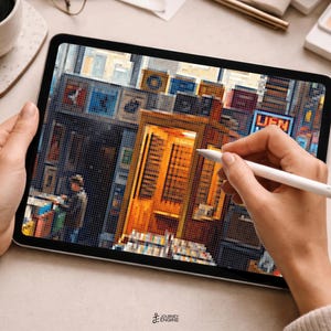 May include: A tablet displaying a pixel art illustration of a city street scene with a prominent golden-yellow telephone booth, various storefronts, and a figure standing nearby. The screen shows a detailed urban environment with vibrant colors.