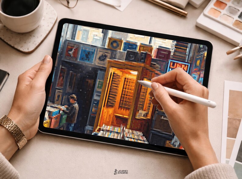 May include: A tablet displaying a pixel art illustration of a city street scene with a prominent golden-yellow telephone booth, various storefronts, and a figure standing nearby. The screen shows a detailed urban environment with vibrant colors.