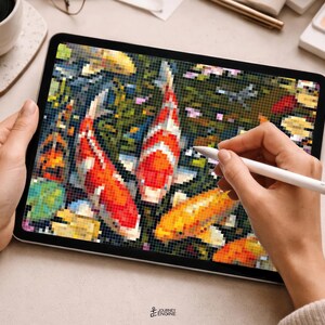 May include: A digital tablet displaying a pixel art illustration of multiple koi fish swimming in a pond. The artwork features vibrant red, orange, and white fish against a dark, textured background. A white stylus is positioned on the screen.