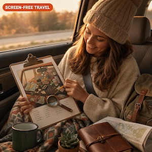 May include: A wooden clipboard featuring a printed illustration of a car interior with various travel items, a magnifying glass, and a list of items to find. The text SCREEN-FREE TRAVEL is visible in the upper left corner of the image.