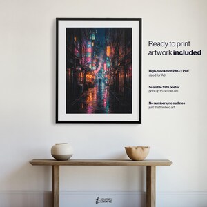 May include: A framed wall art print featuring a dark, rainy city alleyway illuminated by vibrant neon signs in shades of blue, pink, and orange. The text on the right reads: Ready to print artwork included, High-resolution PNG + PDF sized for A3, Scalable SVG poster print up to 60x90 cm, No numbers, no outlines just the finished art.