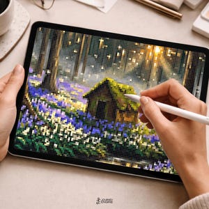 May include: A digital tablet displaying a pixel art illustration of a small cabin nestled in a forest clearing filled with purple and white flowers. The screen shows a grid-based landscape with trees, sunlight filtering through, and a small structure.