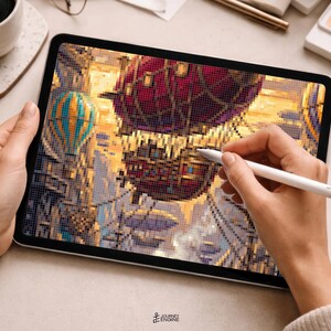 May include: A tablet displaying a pixel art illustration of a large, dark red and brown airship floating in a golden sky, accompanied by a smaller blue and yellow hot air balloon. A white stylus is held against the screen to edit the digital artwork.