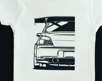 May include: A white baby onesie with a black and white graphic of a car with a spoiler. The car is facing away from the viewer and only the back half of the car is visible.