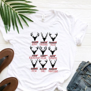 May include: White t-shirt featuring a black reindeer design and red text that reads "Dasher - Jerky", "Dancer - Sausage", "Prancer - Tacos", "Vixen - Backstrap", "Comet - Steak", "Cupid - Burgers", "Donner - Stew", "Blitzen - Chili", and "Rudolph - Nightlight".