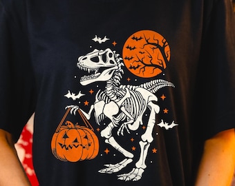 Camiseta de dinosaurio para Halloween, camiseta espeluznante de Trex, camiseta de esqueleto de dinosaurio, camiseta de Halloween, camiseta de temporada espeluznante, regalo de Halloween, camiseta de calabaza de dinosaurio
