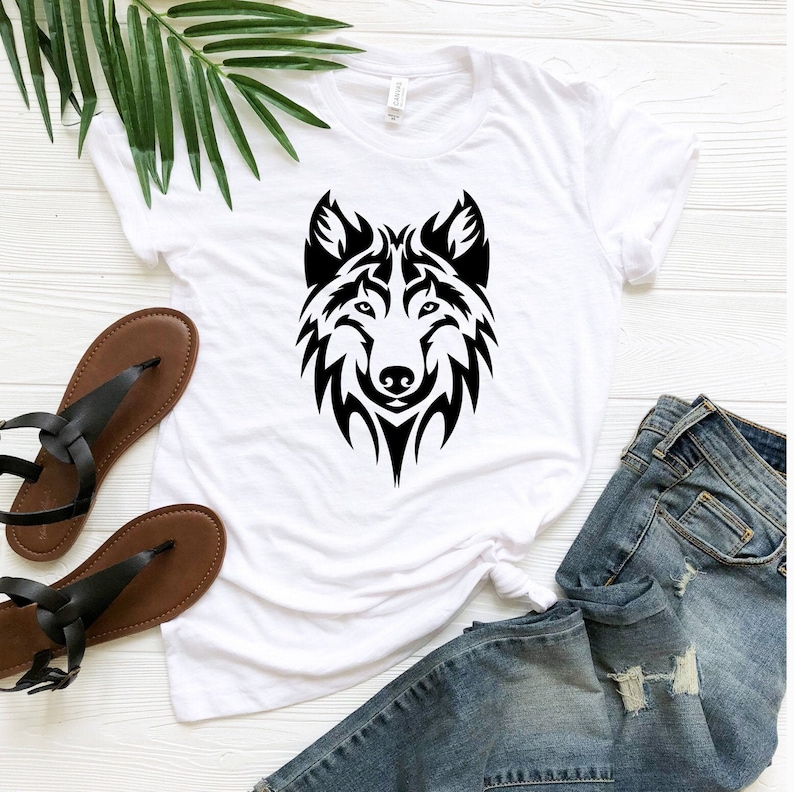 May include: White t-shirt with a black tribal wolf design on the front.