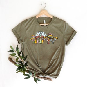 May include: A green t-shirt with a graphic of colorful mushrooms on the front.