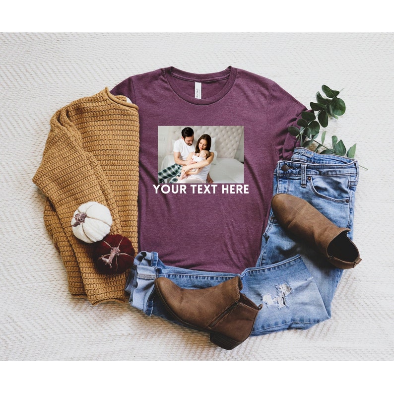 May include: A maroon t-shirt with a photo of a family of three on the front. The text "YOUR TEXT HERE" is printed below the photo.