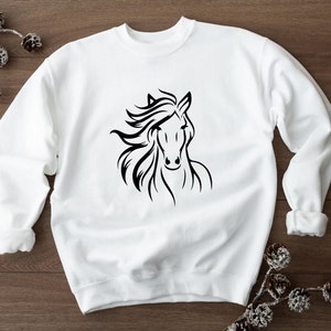 May include: White sweatshirt with a black silhouette of a horse's head.