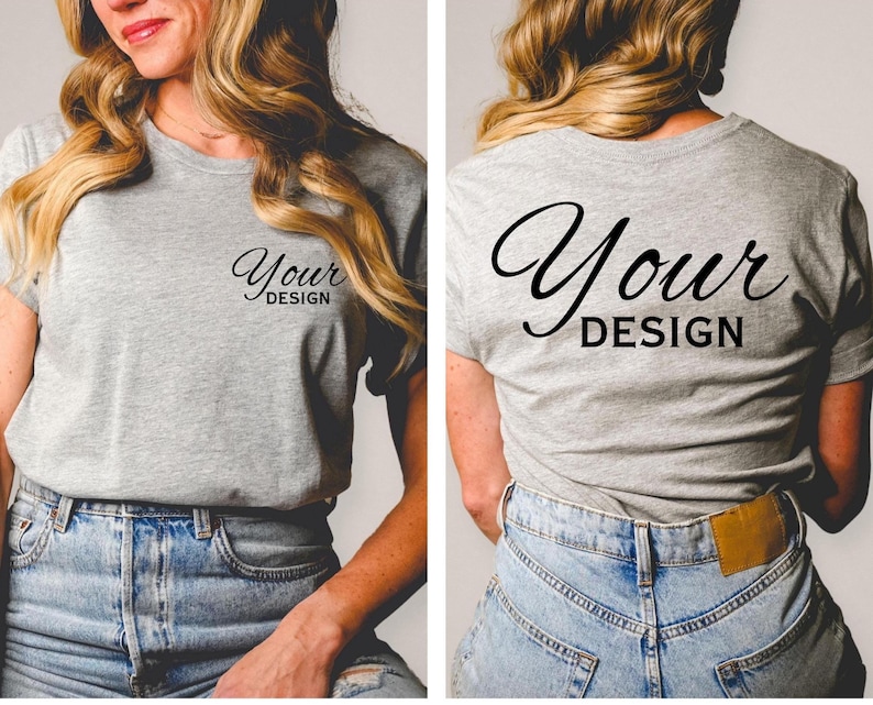 May include: A heather gray t-shirt with the words "Your Design" printed in black script on the front and back. The shirt has a crew neck and short sleeves. The model is wearing blue jeans.
