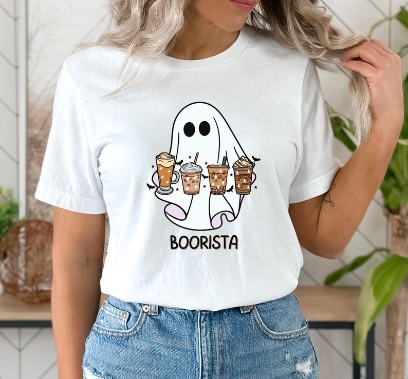 May include: White t-shirt featuring a ghost holding a selection of coffee drinks. The ghost has a friendly face and the text "Boorista" is printed below the ghost.