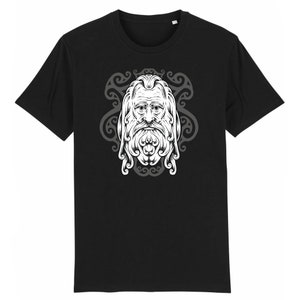 May include: Black t-shirt with a white graphic of a stylized face with a long beard and hair, surrounded by a decorative design.