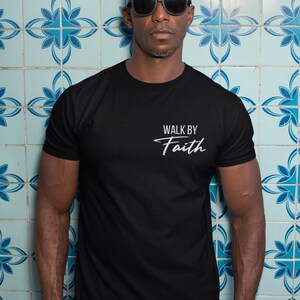 May include: A black t-shirt with the text "Walk by Faith" in white lettering.