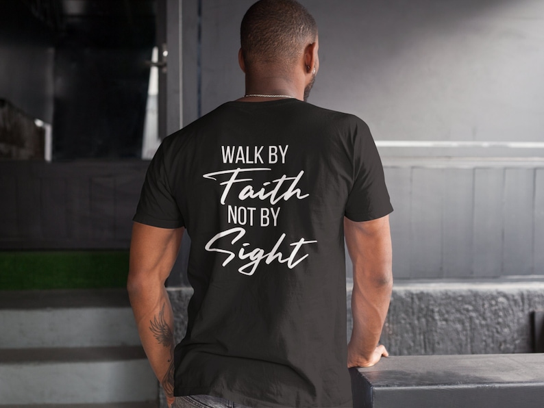 May include: Black t-shirt with white text that reads "Walk by Faith not by Sight".