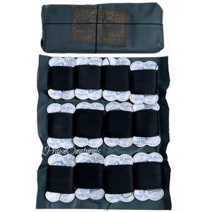 May include: A collection of black thread spools, each with a white label, are arranged on a dark green surface. A wrapped package with text is at the top. The text "Praise Onaturals" is visible. The spools are for sewing or crafts.