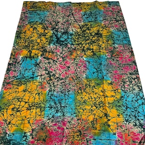 Puede incluir: Una tela colorida con un patr&oacute;n batik en tonos de azul, amarillo, rosa y negro. La tela tiene un efecto tie-dye con un dise&ntilde;o abstracto en espiral.