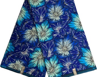 May include: A folded length of fabric with a vibrant floral pattern. The design features large flowers in shades of blue and turquoise, set against a deep blue background. The fabric has a repeating pattern of stylized flowers.