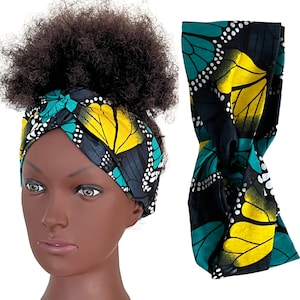 May include: A black, green and yellow patterned headband with a butterfly design. The headband is shown tied in a knot on a mannequin head.