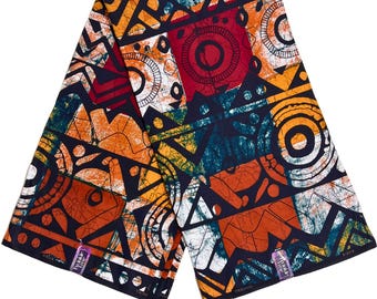 Tecido africano Ankara com estampa em cera, 100% algodão, nas cores preto, verde-azulado, vermelho e azul, com 117 cm de largura.