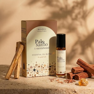 May include: Aromafume Palo Santo & Sandalwood essential oil blend. The product includes a box, a roller bottle, and Palo Santo sticks. The box and bottle have the text "Palo Santo & Sandalwood" and "for good luck". The bottle contains 10ml (0.33 fl. oz.) of oil.