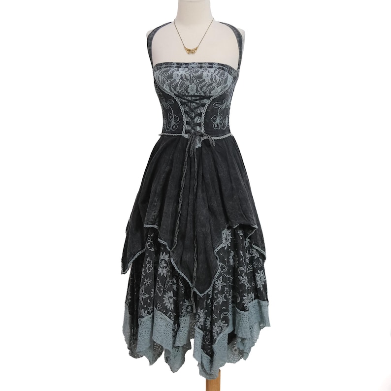 May include: A charcoal gray halter dress featuring a lace bodice with a corset-style lace-up front, a layered handkerchief hemline, and a skirt patterned with celestial motifs including suns, moons, and stars, finished with a light gray lace trim.