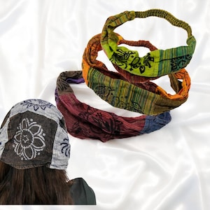 May include: Three colorful headbands with patterned designs. The headbands are in shades of green, orange, red, and blue. The headbands are made of a soft fabric and are designed to be worn around the head. A patterned hat is also visible.