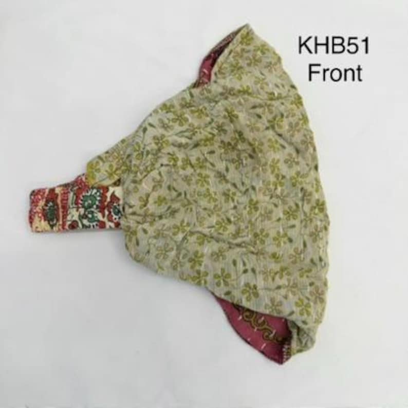 May include: A fabric head covering with a light green exterior featuring a small floral pattern and a contrasting dark pink interior with a decorative border. The item is labeled with the text KHB51 Front in the upper right corner.