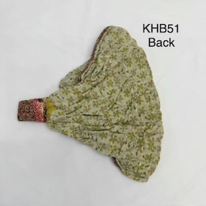 May include: A quilted fabric headband featuring a light green base with a repeating dark green floral pattern. The headband has a gathered texture and a multi-colored patterned fabric section on the left side. The text KHB51 Back is visible.